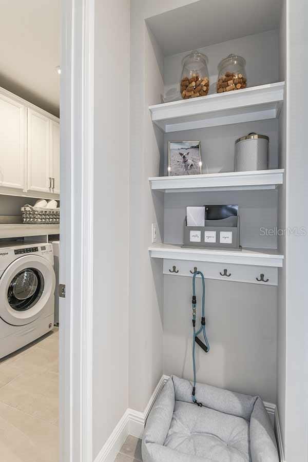 laundry area with washer / clothes dryer and cabinets