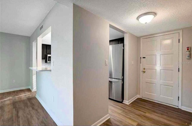 entryway featuring a textured ceiling and hardwood / wood-style flooring