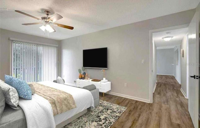 bedroom with ceiling fan, wood-type flooring, and a textured ceiling