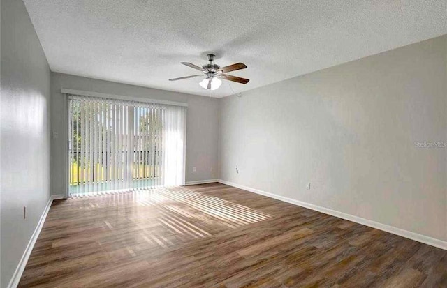 unfurnished room featuring ceiling fan, dark hardwood / wood-style flooring, and a textured ceiling