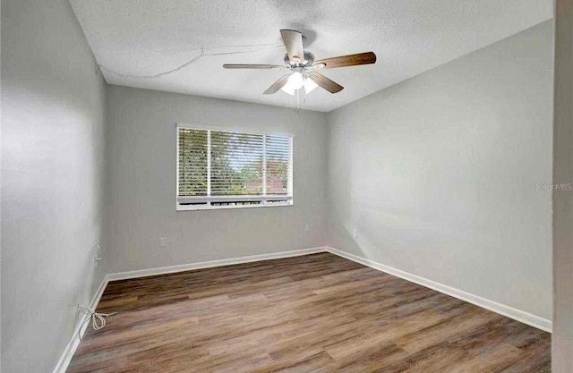 unfurnished room with ceiling fan, hardwood / wood-style floors, and a textured ceiling