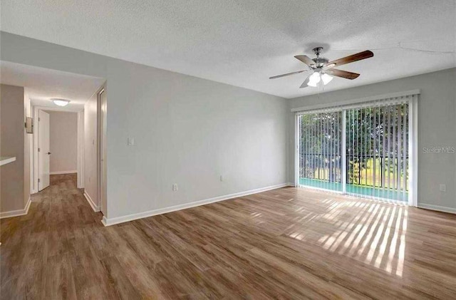 unfurnished room featuring hardwood / wood-style floors, a textured ceiling, and ceiling fan