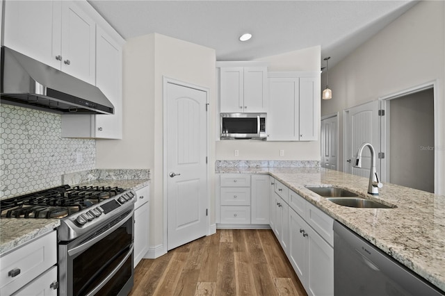 kitchen with stainless steel appliances, white cabinetry, and sink