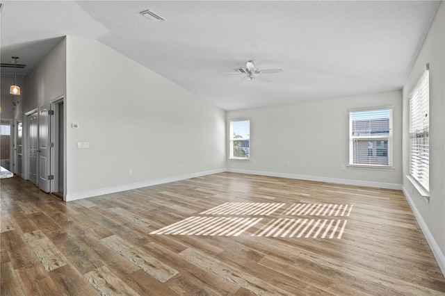 spare room featuring hardwood / wood-style floors, ceiling fan, and lofted ceiling