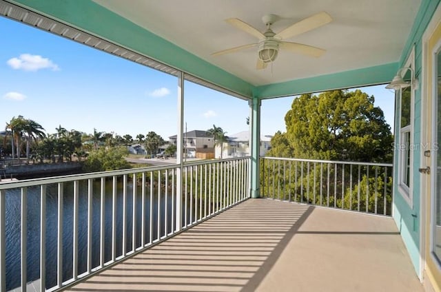 unfurnished sunroom featuring ceiling fan