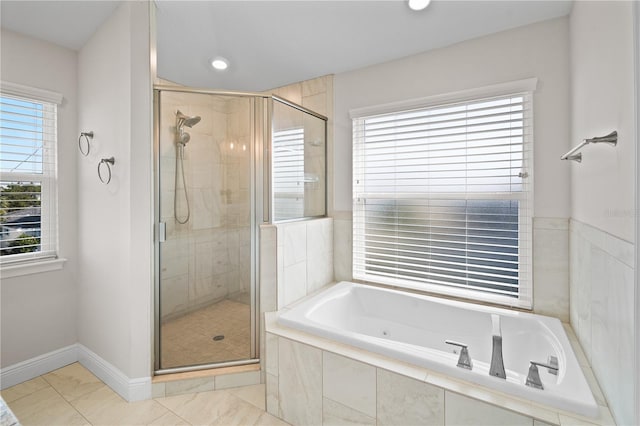 bathroom featuring tile patterned flooring, a healthy amount of sunlight, and independent shower and bath