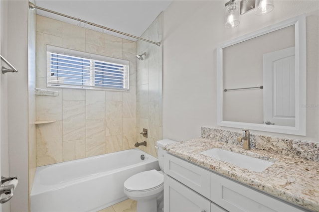 full bathroom featuring tiled shower / bath combo, toilet, and vanity