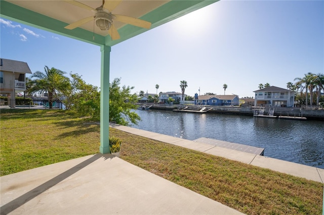 exterior space featuring a lawn, a patio area, and a water view