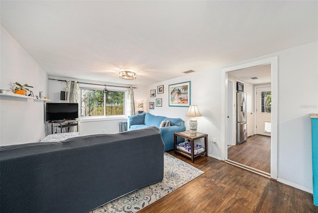 living room with dark hardwood / wood-style flooring