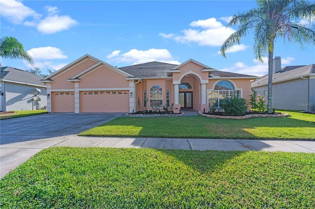 view of front of home with a garage and a front lawn