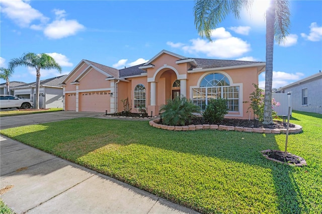 view of front facade with a front yard and a garage