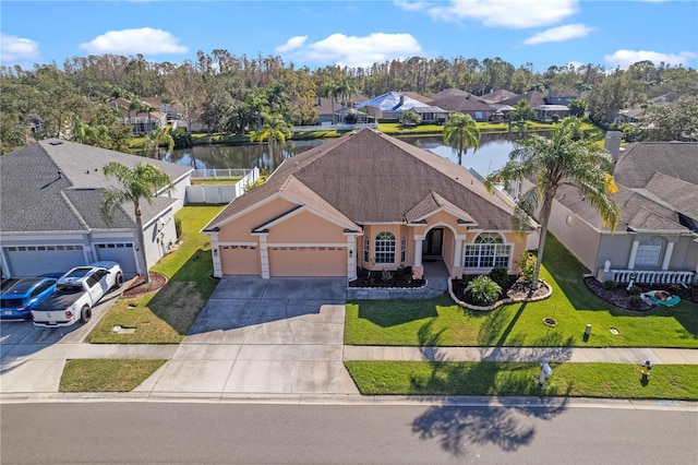 view of front of home with stucco siding, a residential view, concrete driveway, and a front lawn