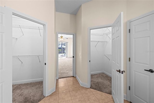 bathroom with ceiling fan and tile patterned flooring