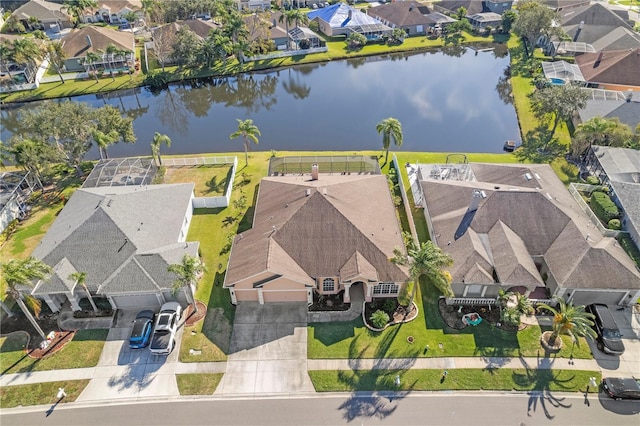 drone / aerial view featuring a residential view and a water view