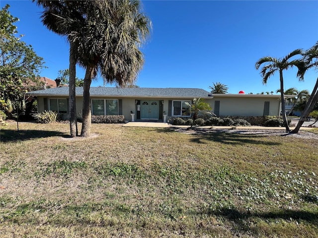 ranch-style home featuring a front lawn