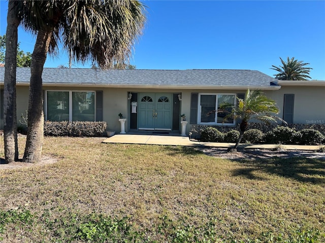 ranch-style home with a front lawn