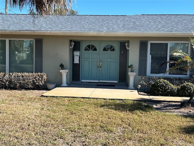 property entrance with a yard