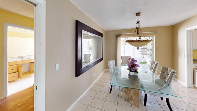 dining area featuring light tile patterned floors and sink