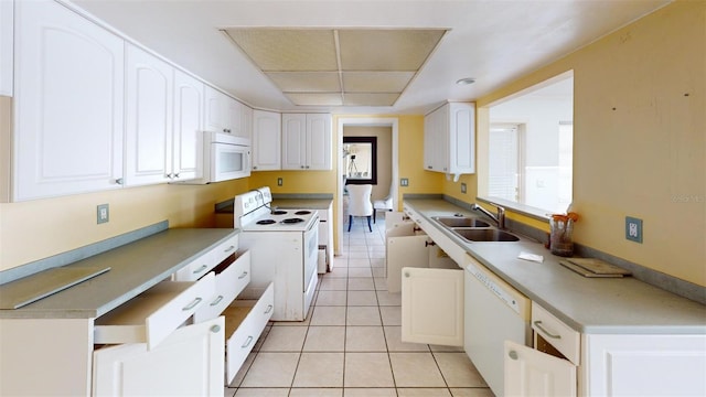 kitchen featuring white cabinetry, white appliances, sink, and light tile patterned floors