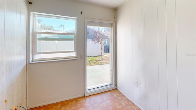 doorway featuring wood walls