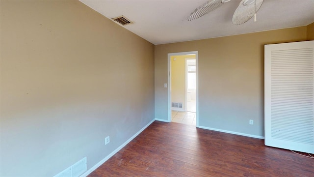 spare room with ceiling fan and dark hardwood / wood-style floors