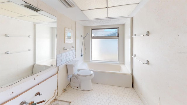 bathroom with bathing tub / shower combination and toilet