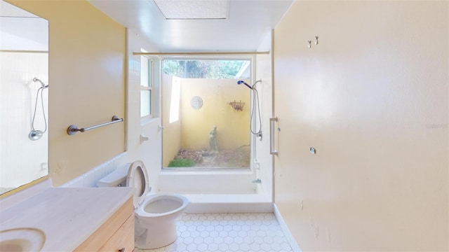 bathroom featuring vanity, toilet, and a shower