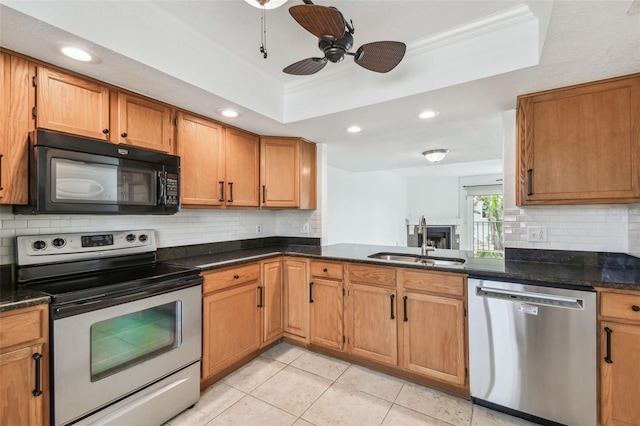 kitchen featuring light tile patterned flooring, stainless steel appliances, a sink, decorative backsplash, and a raised ceiling