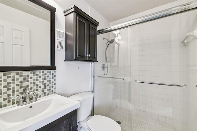 full bathroom featuring tasteful backsplash, visible vents, toilet, a stall shower, and vanity