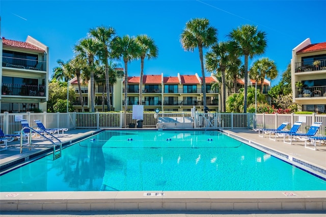 community pool featuring a patio area and fence