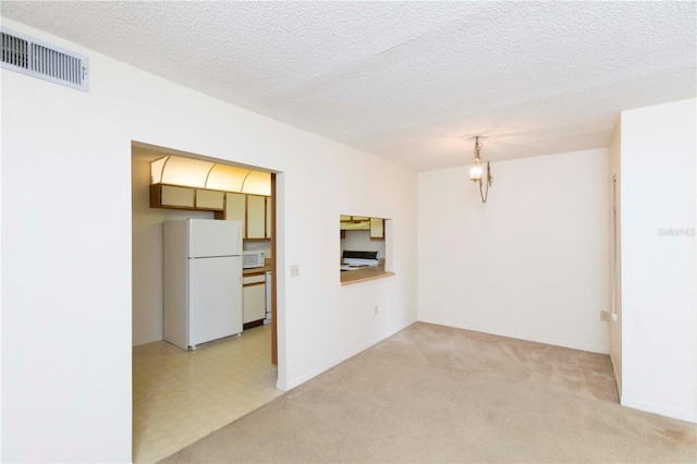 12119 Sunny Glen Ln Unit F1, Hudson, FL 34669 - unfurnished living room with light colored carpet and a textured ceiling