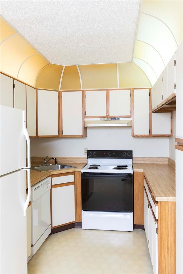 kitchen with white cabinets, a textured ceiling, white appliances, and sink