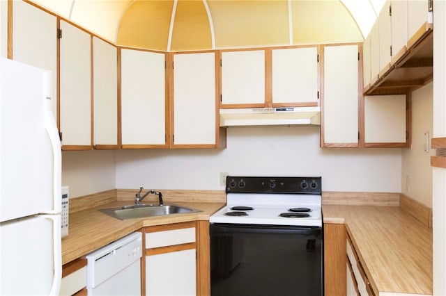 kitchen with white appliances, white cabinetry, and sink