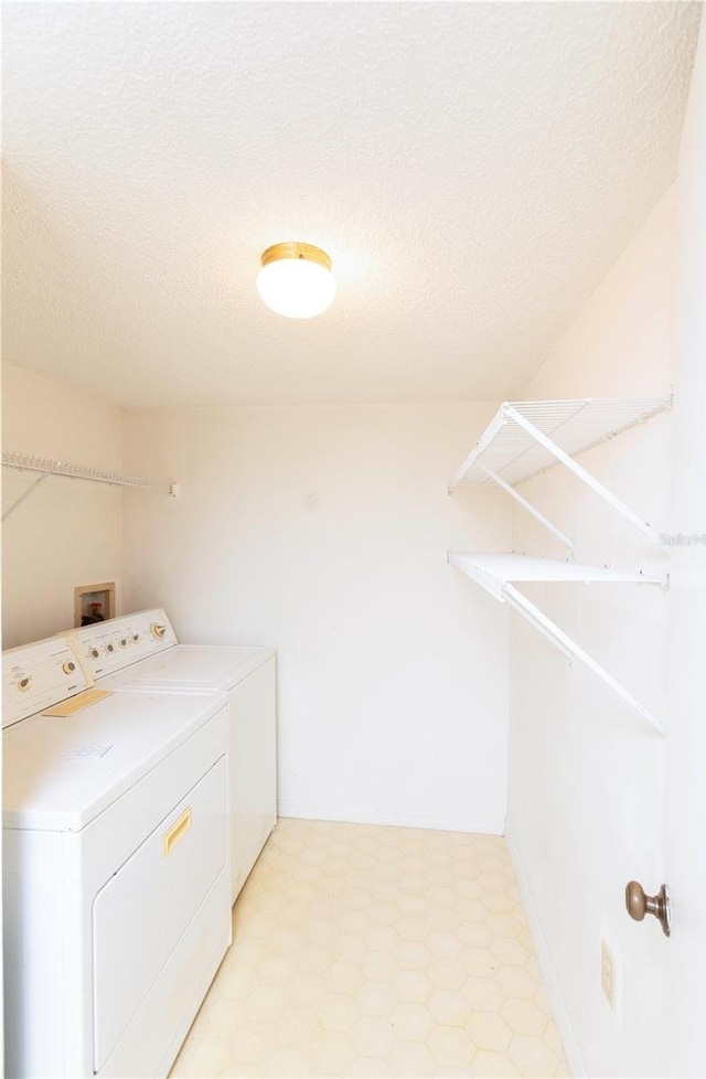 12119 Sunny Glen Ln Unit F1, Hudson, FL 34669 - washroom featuring washing machine and clothes dryer and a textured ceiling