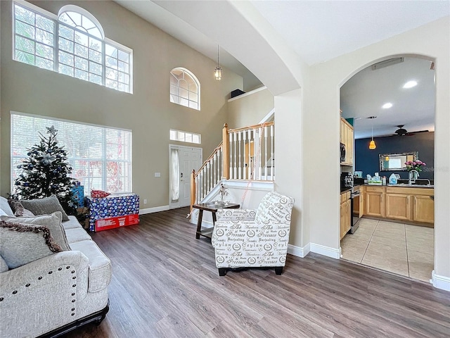 living room with light hardwood / wood-style flooring and ceiling fan