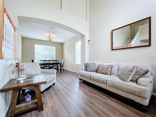 living room with hardwood / wood-style flooring and an inviting chandelier