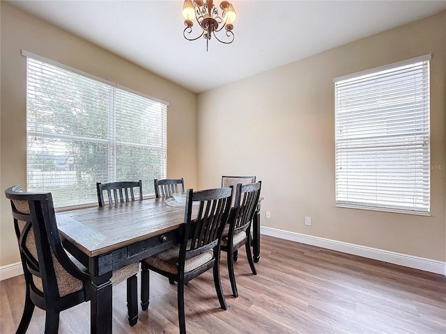 dining room featuring a chandelier and hardwood / wood-style flooring