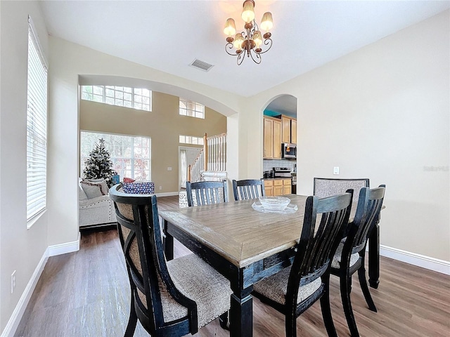 dining room featuring a notable chandelier and dark hardwood / wood-style flooring