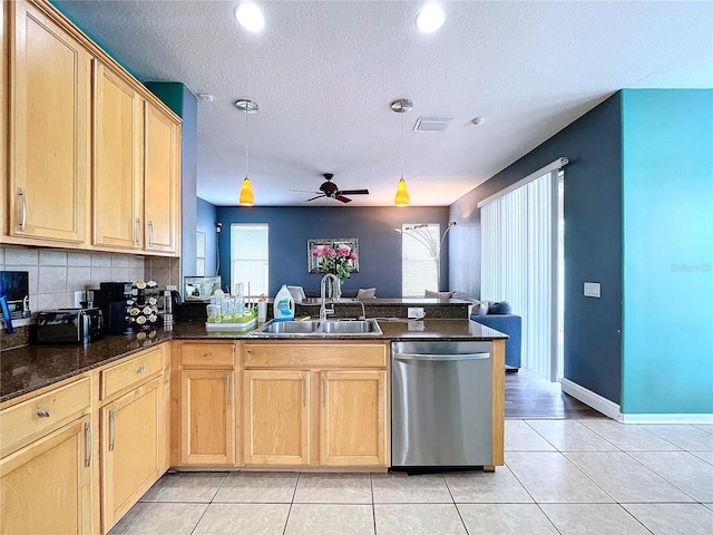 kitchen featuring dishwasher, sink, backsplash, kitchen peninsula, and pendant lighting