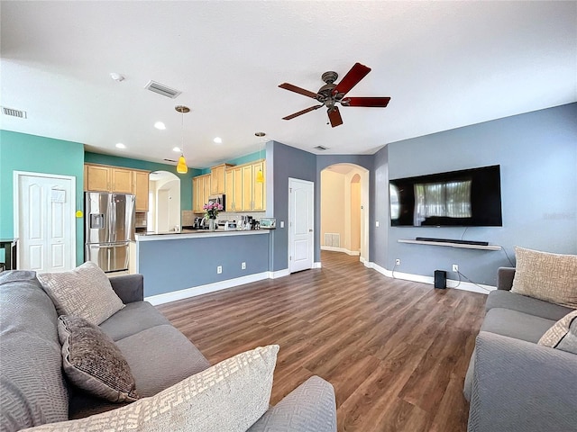 living room with dark hardwood / wood-style floors and ceiling fan