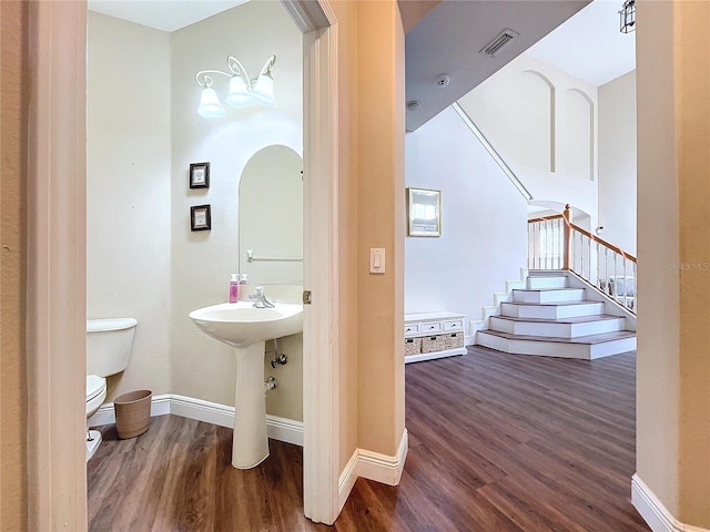 bathroom featuring sink, toilet, and hardwood / wood-style flooring