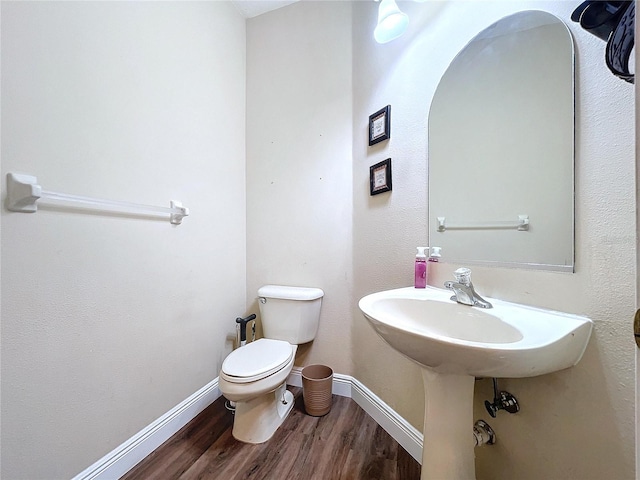 bathroom featuring hardwood / wood-style floors and toilet