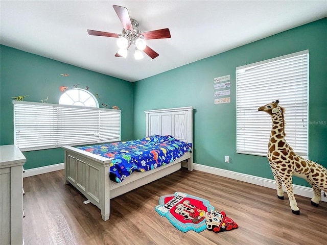 bedroom featuring hardwood / wood-style floors and ceiling fan