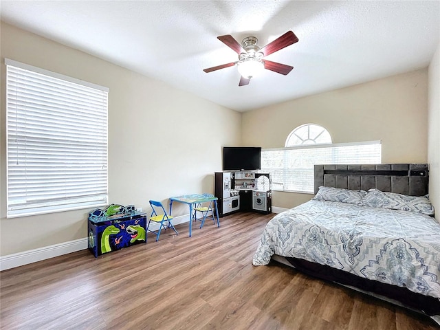 bedroom with hardwood / wood-style floors and ceiling fan