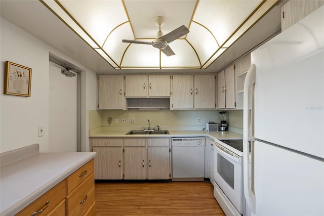 kitchen featuring ceiling fan, sink, white appliances, and light wood-type flooring