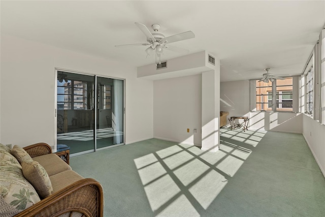 carpeted living room featuring ceiling fan