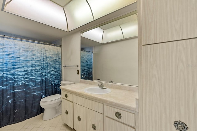 bathroom featuring tile patterned floors, vanity, and toilet