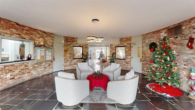 interior space featuring brick wall and a chandelier