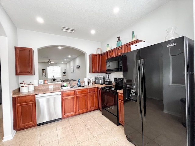 kitchen featuring ceiling fan, sink, a textured ceiling, light tile patterned flooring, and black appliances