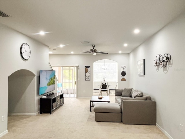 living room with ceiling fan and light colored carpet